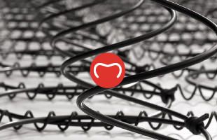 Hog ring staples used to attach coated wires to sprung mattress springs